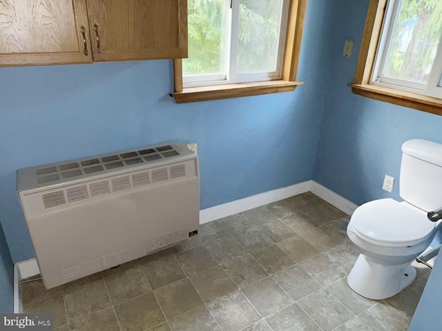 bathroom featuring toilet and radiator heating unit