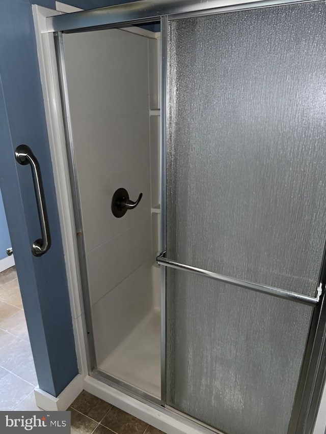 bathroom featuring tile patterned flooring and walk in shower