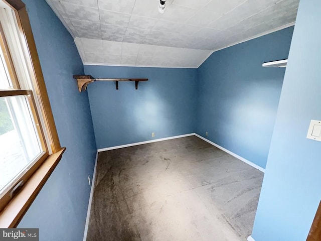 unfurnished room with lofted ceiling