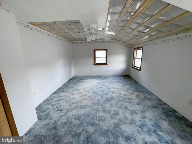 carpeted spare room with ceiling fan