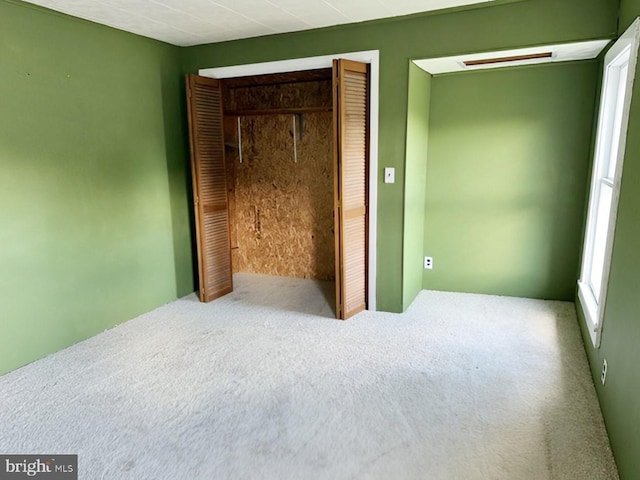 unfurnished bedroom with carpet floors and a closet