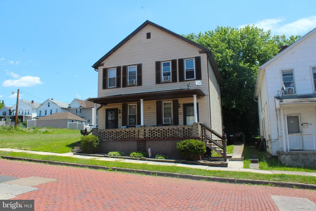 view of front of house featuring a porch and a front yard