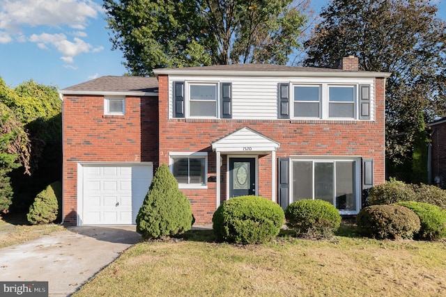 view of front of property with a front lawn and a garage