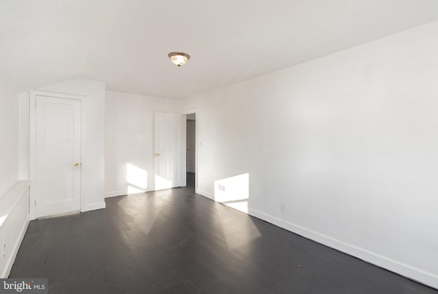 empty room featuring dark hardwood / wood-style flooring