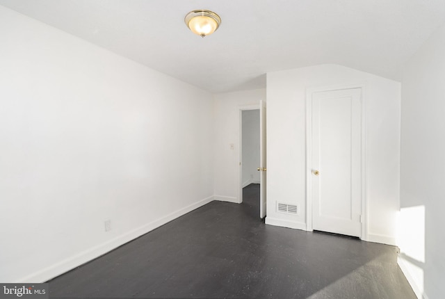 unfurnished bedroom with vaulted ceiling