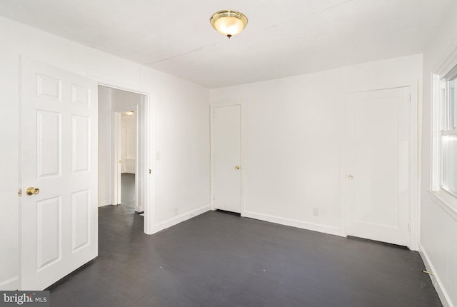 spare room with dark hardwood / wood-style floors