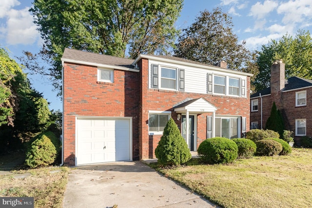 view of front of home with a front yard and a garage