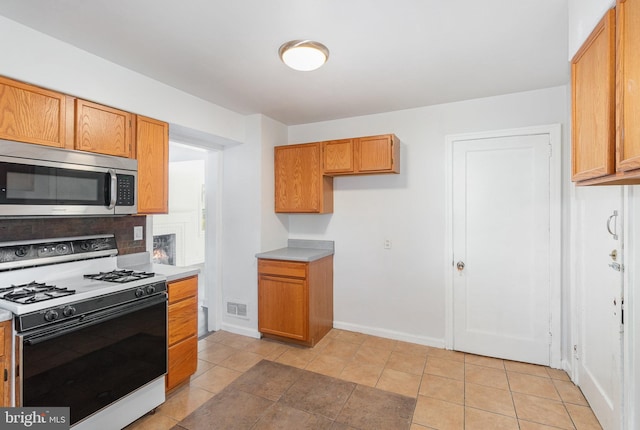 kitchen with light tile patterned flooring and white range