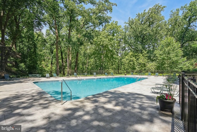 view of swimming pool with a patio area