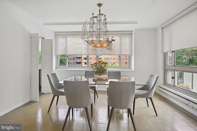 dining room featuring a baseboard radiator and a chandelier