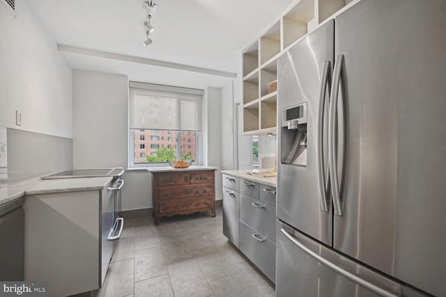 kitchen featuring stainless steel fridge with ice dispenser, gray cabinets, track lighting, and light tile patterned flooring