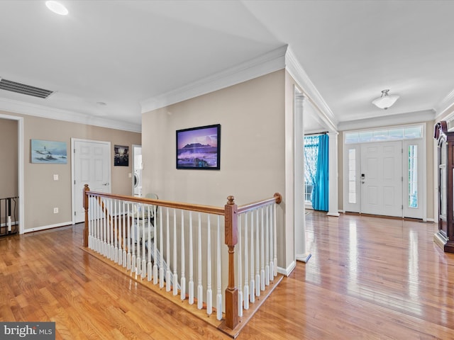 entrance foyer with hardwood / wood-style floors and crown molding