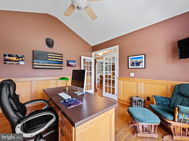 home office with ceiling fan, light wood-type flooring, french doors, and lofted ceiling