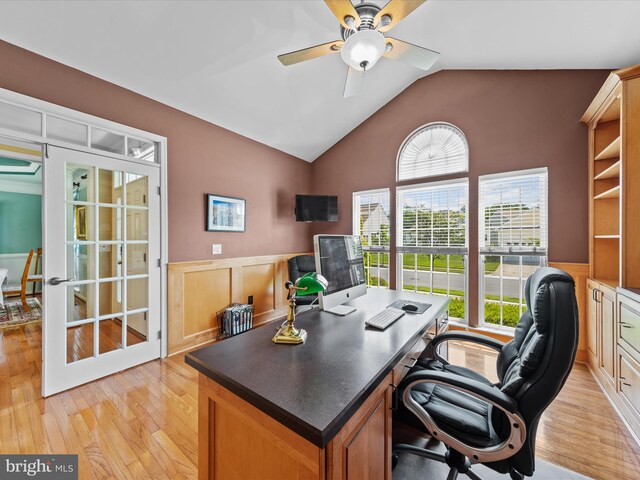 home office featuring ceiling fan, light wood-type flooring, french doors, and lofted ceiling