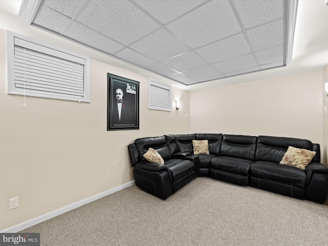 carpeted living room with a paneled ceiling