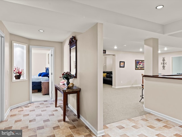 hallway with light colored carpet