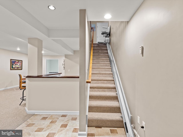 staircase with light carpet