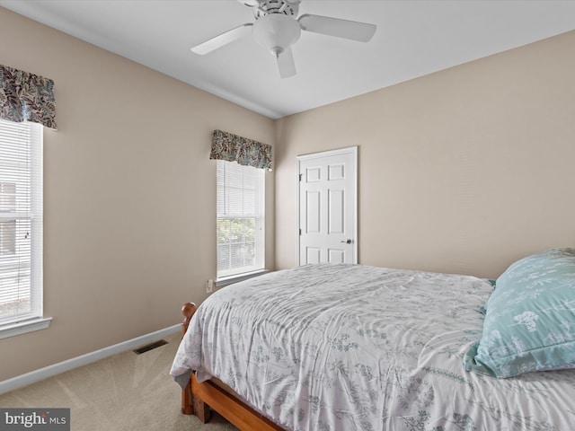 bedroom featuring ceiling fan and carpet