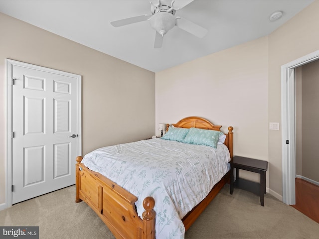 bedroom featuring ceiling fan and light colored carpet