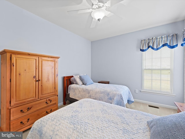 bedroom with ceiling fan and light carpet