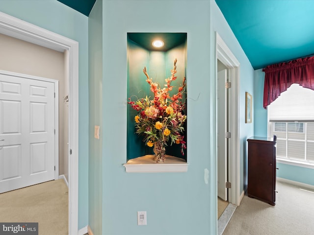 hallway with light colored carpet