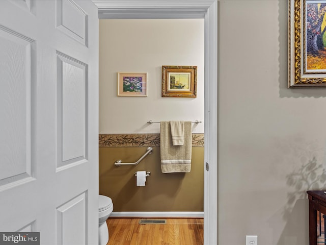 bathroom featuring toilet and hardwood / wood-style floors