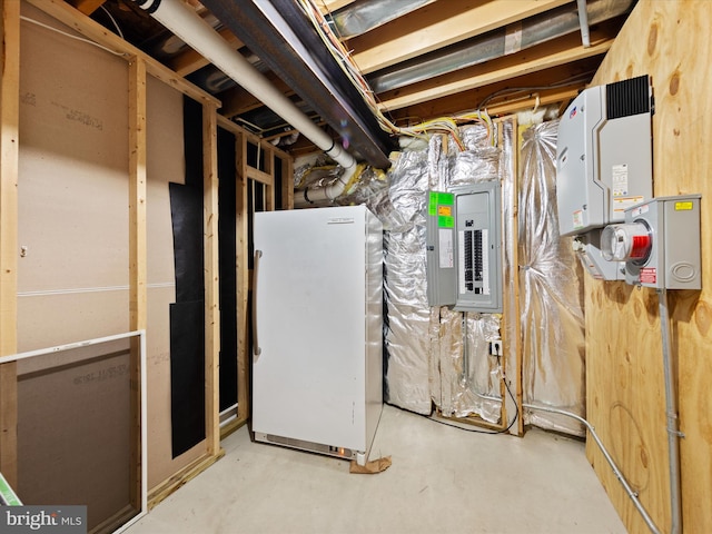 basement with electric panel and white fridge