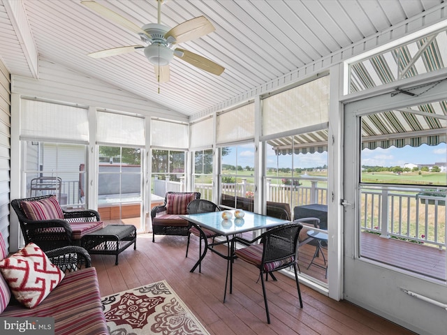 sunroom / solarium featuring ceiling fan, lofted ceiling, and a healthy amount of sunlight