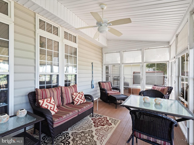 sunroom / solarium with ceiling fan and lofted ceiling