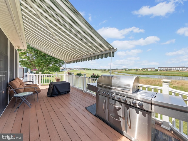 wooden terrace featuring a water view