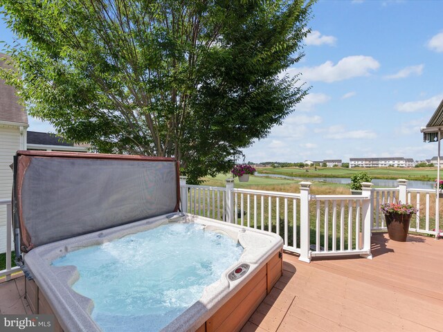 deck with a covered hot tub