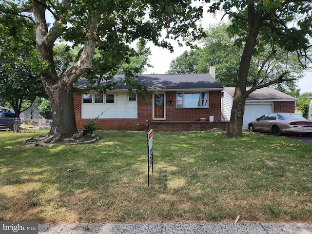 view of front of home featuring a garage and a front lawn