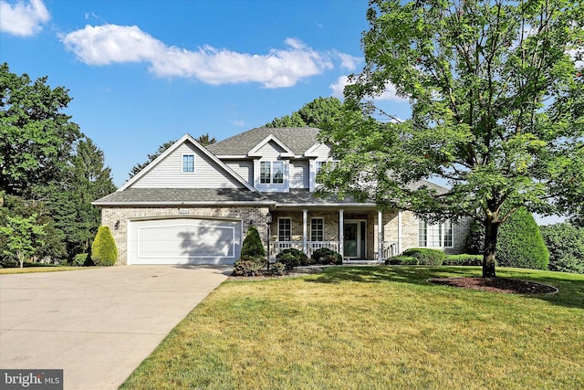 view of front of home featuring covered porch, a garage, and a front yard