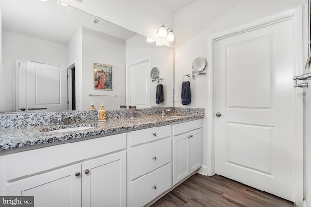 bathroom with vanity and hardwood / wood-style flooring