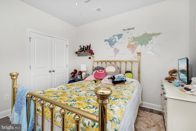 bedroom with hardwood / wood-style floors and a closet