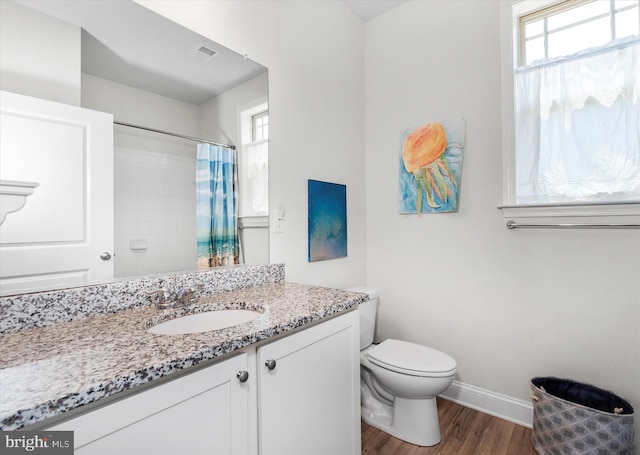 bathroom featuring a shower with shower curtain, vanity, wood-type flooring, and toilet