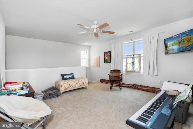 sitting room featuring carpet flooring and ceiling fan