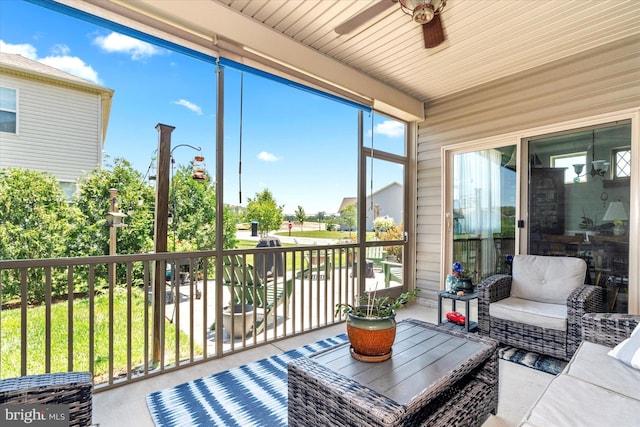 sunroom / solarium featuring ceiling fan