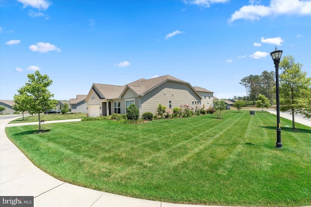 view of front of house featuring a garage and a front lawn