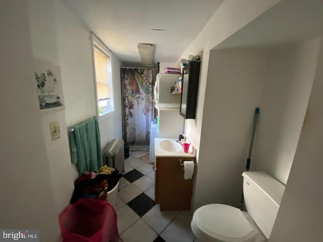 bathroom featuring a shower with shower curtain, tile patterned floors, vanity, washer / clothes dryer, and toilet