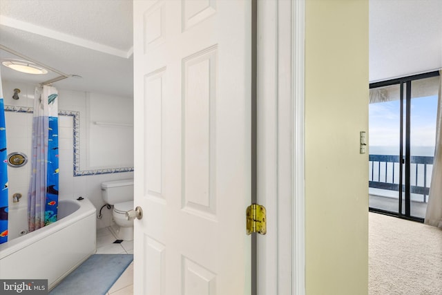 bathroom featuring tile patterned floors, a textured ceiling, shower / tub combo with curtain, a water view, and toilet