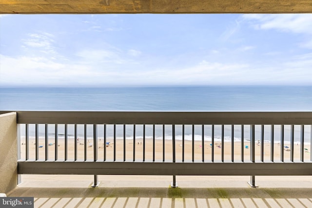 deck featuring a water view and a view of the beach