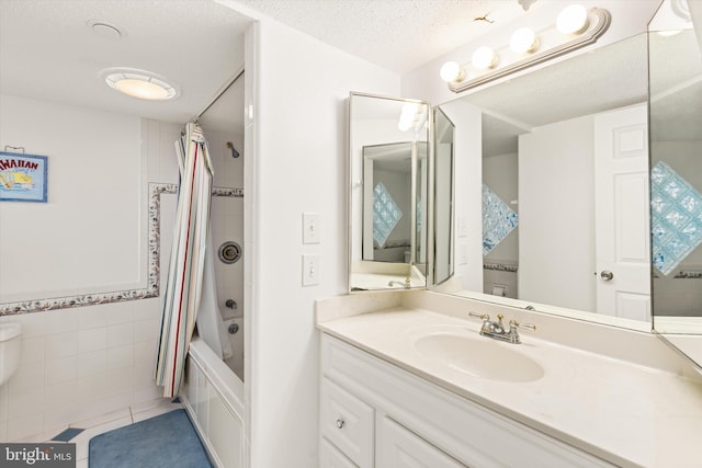 bathroom with vanity, tile patterned floors, tile walls, a textured ceiling, and shower / tub combo with curtain