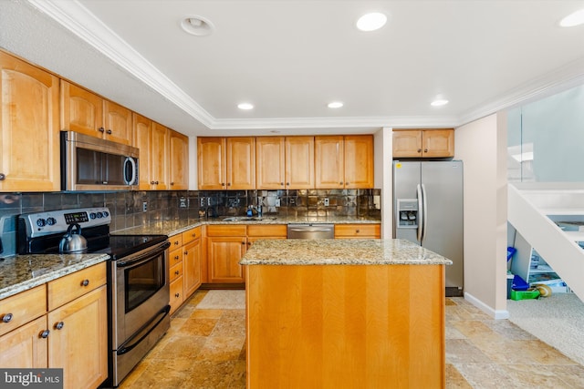 kitchen featuring decorative backsplash, a center island, stainless steel appliances, and light stone countertops