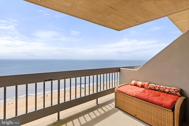 balcony with a water view and a beach view