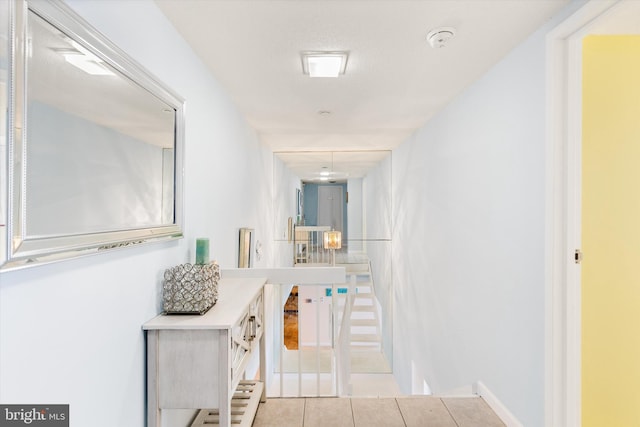 hall featuring light tile patterned floors