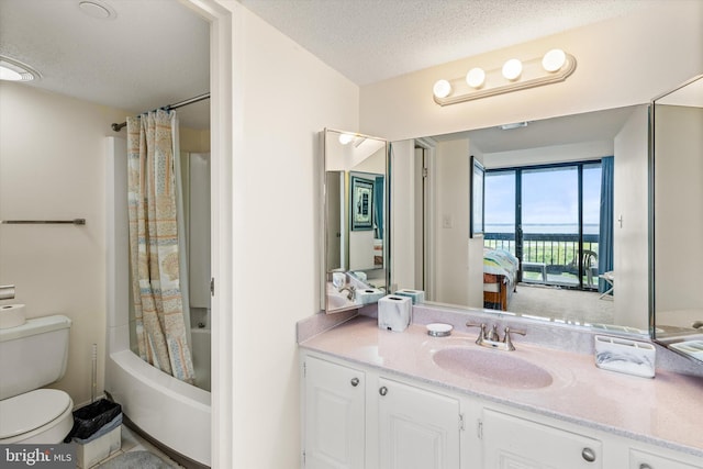 full bathroom with vanity, tile patterned flooring, toilet, a textured ceiling, and shower / tub combo