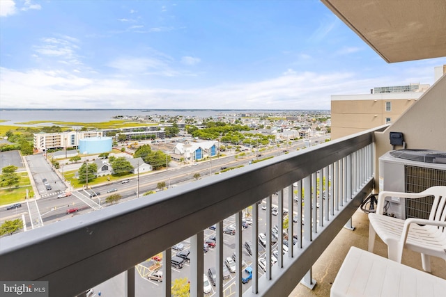 balcony with a water view and central AC unit