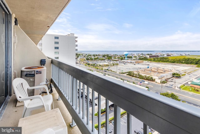 balcony featuring a water view and central AC