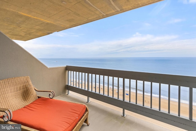 balcony featuring a beach view and a water view